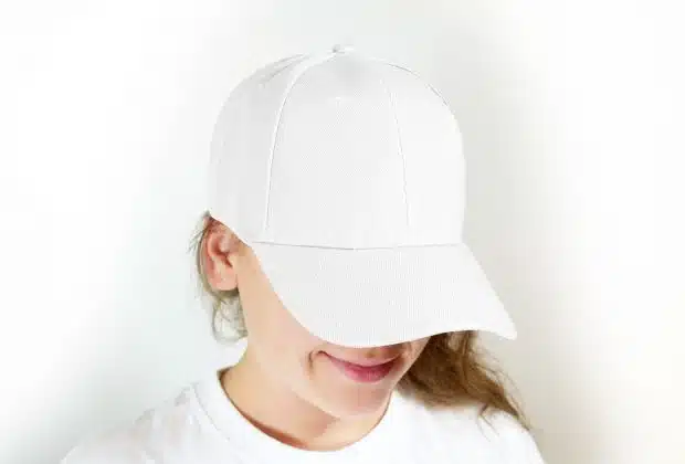 woman in white crew neck shirt wearing white cap